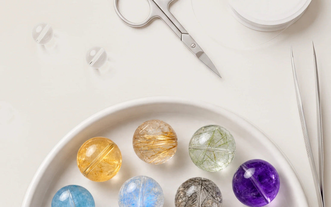 Colorful natural crystal beads arranged in a design tray beside bracelet-making tools